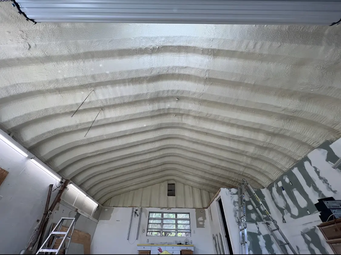 Spray polyurethane foam applied to the underside of a metal roof deck in Byron